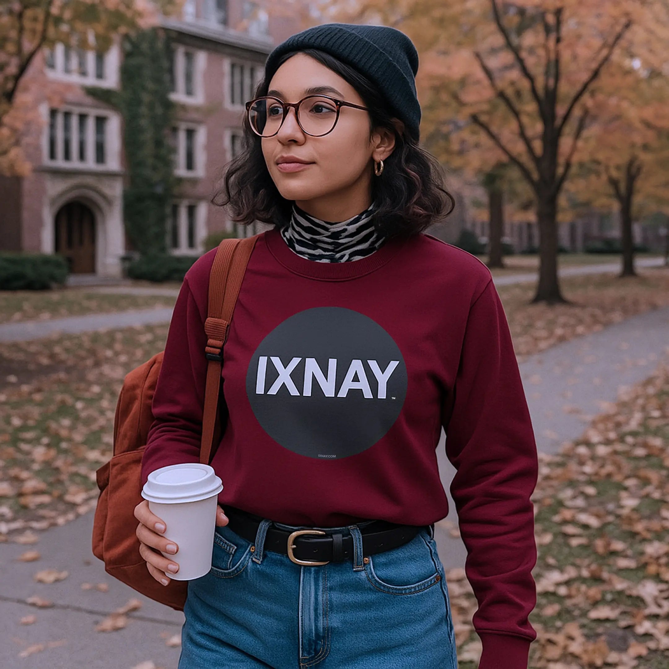 young woman walking to class on a college campus wearing maroon red IXNAY Original Logo 100% cotton long-sleeved t-shirt