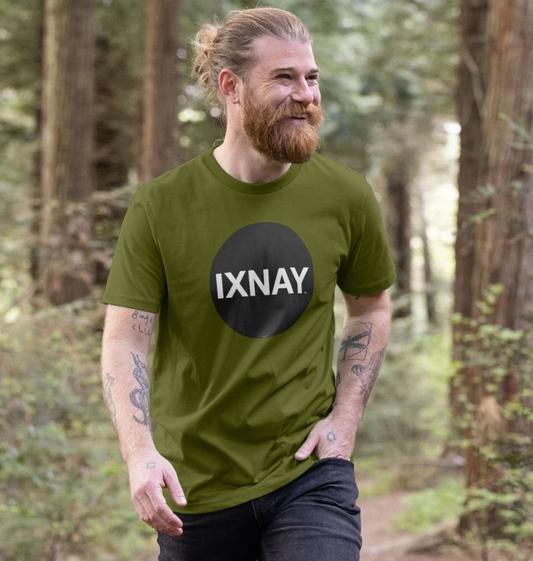 Man smiling and laughing whiel hiking and wearing a moss green Printed Men's T-Shirt with Original Black Round IXNAY Logo to represent the artist and musician IXNAY