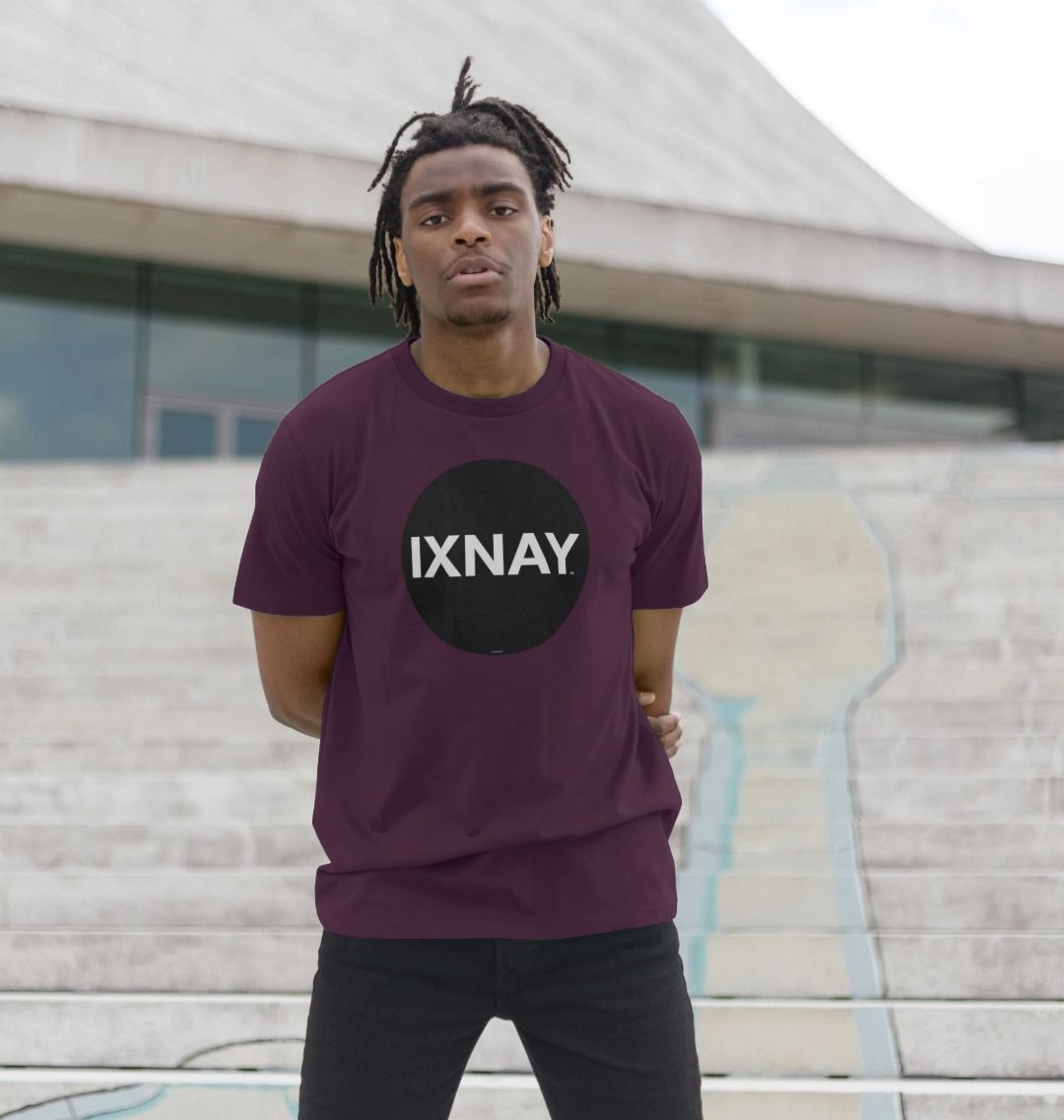 Black man on steps modern urban building wearing a purple Printed Men's T-Shirt with Original Black Round IXNAY Logo to represent the artist and musician IXNAY